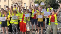 Oxfam-Beschäftigte während der "Kämpferischen Mittagspause" mit Plakaten und Warnwesten